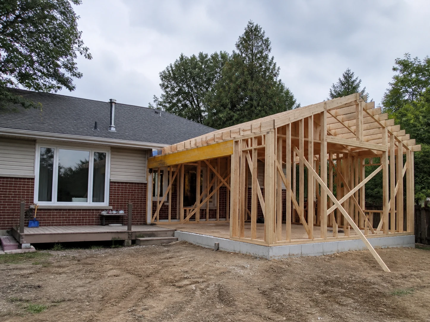 Illustrative timber-framed addition connected to an existing house